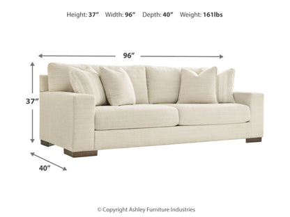 Image of a cream-colored Maggie Sofa with dimensions labeled: Height 37", Width 96", Depth 40". The sofa features plush cushions and two accent pillows. Weight is 161 lbs. Copyright Ashley Furniture Industries.