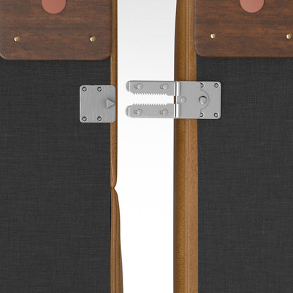 Two wooden folding panels connected by a silver latch hinge mechanism. The panels have black fabric sections and a brown leather accent with brass rivets on top. The hinge is centrally positioned, allowing the panels to fold together.