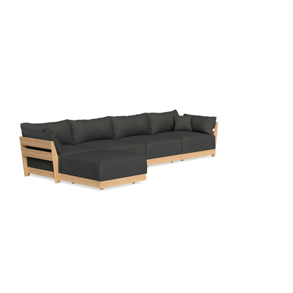 The Modular Bondi Latte 4 Seater Sectional features a modern design with a wooden frame and dark gray cushions. It includes a chaise lounge section, perfect for both sitting and reclining, and showcases minimalist lines with an open-sided style on one end.