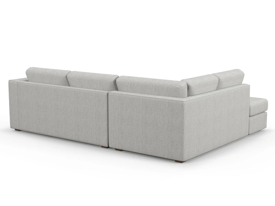 Introducing the Lounge Bumper Sectional, a modern sectional sofa in light gray with a sleek design. It features plush cushions and a right-angle configuration. The upholstery is soft and comfortable, embodying a minimalist style perfect for contemporary living spaces.