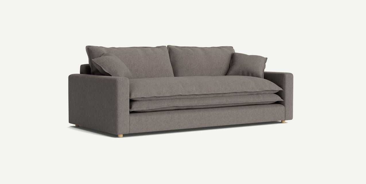 Introducing the Meriwether Sofa: a modern two-seater with plush cushions, featuring a sleek gray hue and minimalist design. This stylish piece showcases a clean, boxy shape complemented by subtle wooden legs, all set against a plain white background.