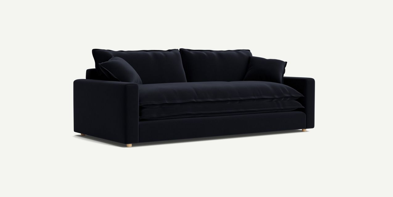 The Meriwether Sofa, a sleek and modern piece in black with plush cushions, stands against a plain light background. It boasts clean lines and wooden legs, offering a minimalist and stylish look.