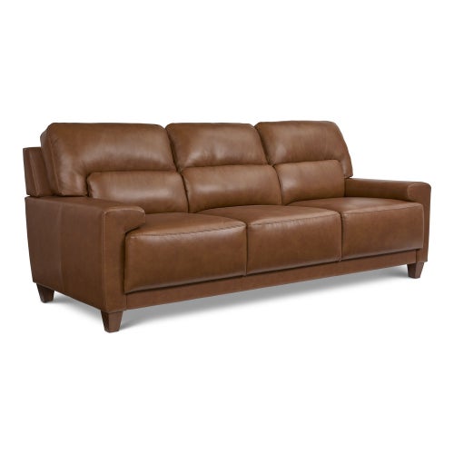 The Draper Sofa is a brown leather piece with three cushioned seats and armrests that showcases a contemporary design with wooden legs, set against a plain white background.