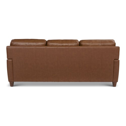 The Draper Sofa, showcased against a white background, is a brown leather piece with three seat sections and wooden legs, viewed from the back.