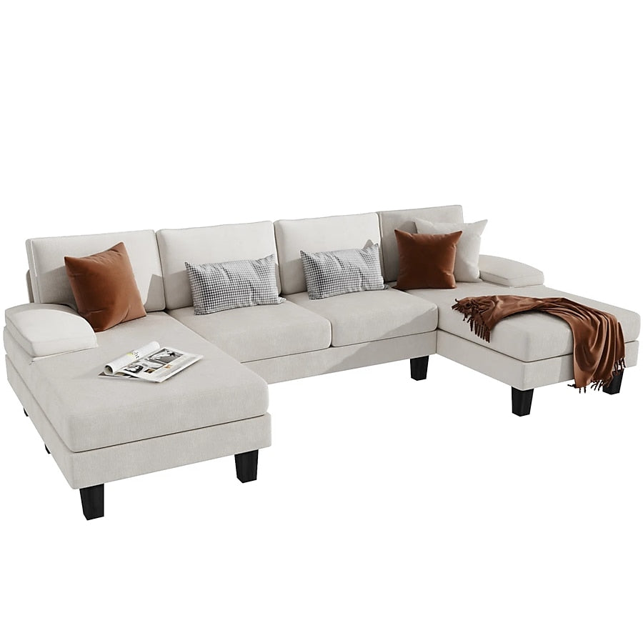 The Vineego Modern Gray Chenille Sectional, featuring a chaise lounge and an open end on the opposite side, is elegantly styled with black legs. It is adorned with brown, gray, and checkered pillows, complemented by a brown throw blanket and an open magazine.