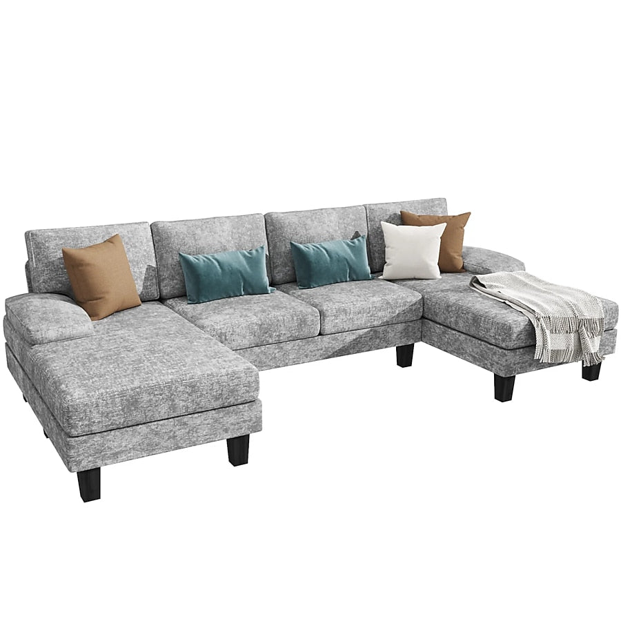 The Vineego Modern Gray Chenille Sectional is adorned with black legs and includes seven cushions in shades of brown, blue, and gray. A green and white striped throw blanket elegantly drapes over one end of this L-shaped sofa.