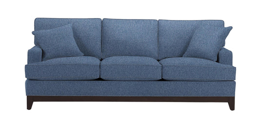 Experience the minimalist design of the Arcata Sofa, Quick Ship, featuring a blue upholstery with three back cushions and two matching throw pillows. Supported by a dark wooden base, it boasts clean, straight lines.