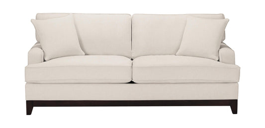 The Arcata Sofa, Quick Ship, features a sleek design with a cream-colored finish, complemented by four matching cushions and dark wooden legs.