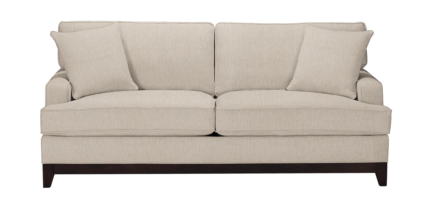 The Arcata Sofa, Quick Ship features a simple and modern design with a beige finish, dark wooden legs, and two matching cushions on each side.