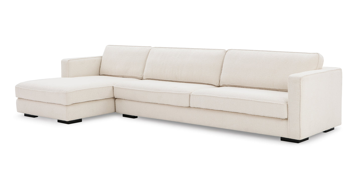 The Architect 133" Fabric Sofa Sectional Left in Blanc Boucle is a modern L-shaped sofa with cushioned backrests, wide armrests, and a chaise lounge on the left side. It stands on sturdy black legs and features a sleek design perfect for contemporary living spaces.