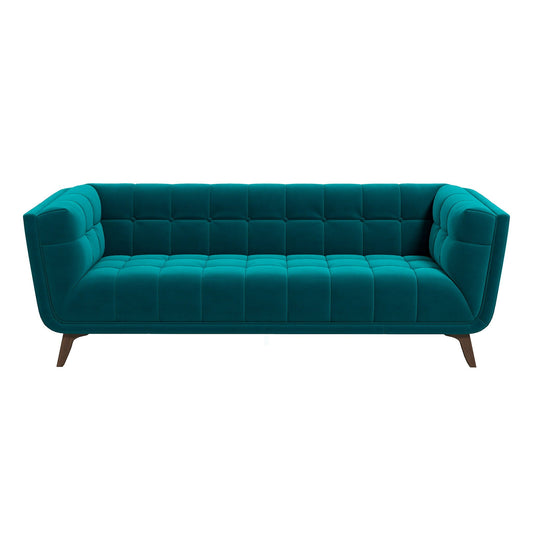 The Addison sofa boasts a teal, mid-century modern design with tufted back and seat, outward-angled wooden legs, boxy shape, and smooth velvet-like texture for stylish comfort.