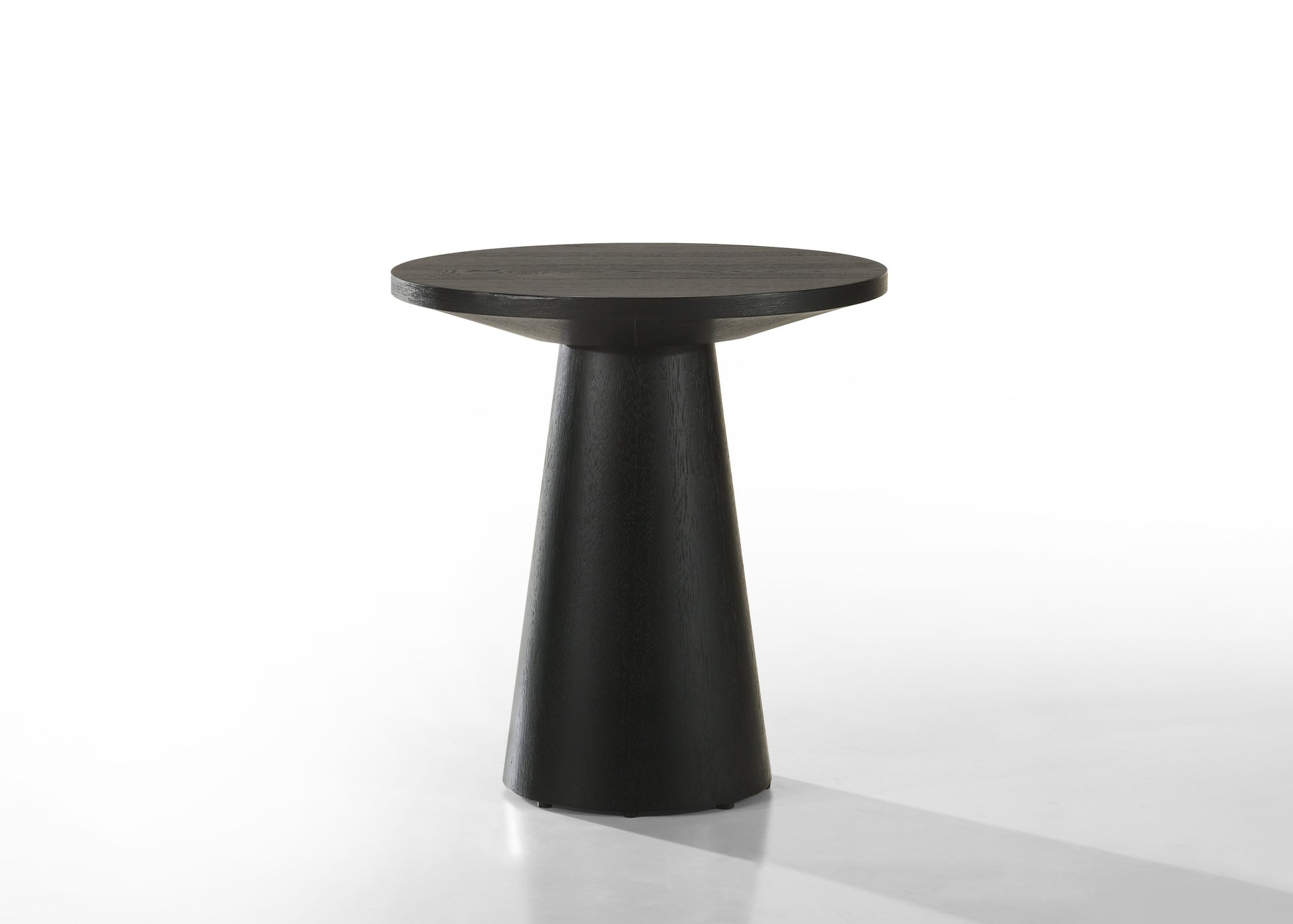 The Jasper Round Table features a sleek, black design with a smooth circular top and conical base, set against a plain white background.