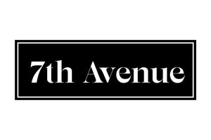 A black rectangular sign with a white border displaying the text "7th Avenue" in white serif font against a black background.