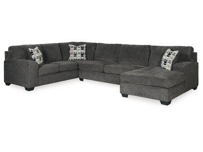 Introducing the Ballinasloe 3-Piece Sectional with Chaise, featuring a spacious dark gray design with a right-side chaise. This modern sofa comes complete with four stylish black and white patterned throw pillows and low block feet for a contemporary look.