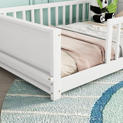 A white floor platform bed with a built-in book storage rack features a pink blanket on top, set on a light blue textured rug. A stuffed bear toy is partially visible, near the bed and close to a light green wall.