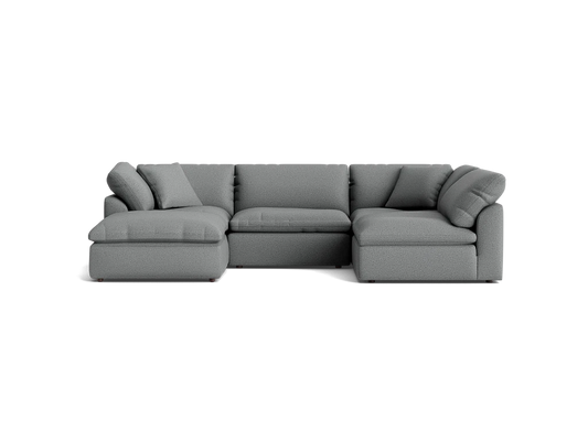 A stylish Bryant U-Sofa Bumper Sectional in gray, featuring plush cushions and a left-hand chaise, set against a solid black background.