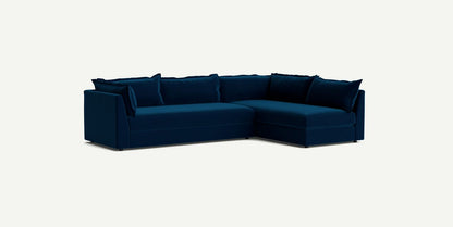 The Denver Two Piece Velvet L Shaped 119" Sectional in modern dark blue features a right-hand chaise and comes with matching cushions, all set against a light background.