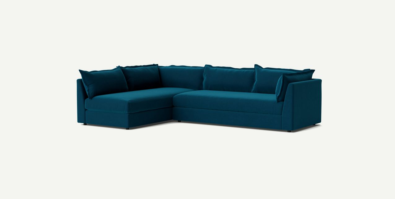 The Denver Two Piece Velvet L Shaped 119" Sectional features a modern design with its teal color, clean lines, and plush upholstery, complemented by several matching cushions, all showcased against a plain white background.