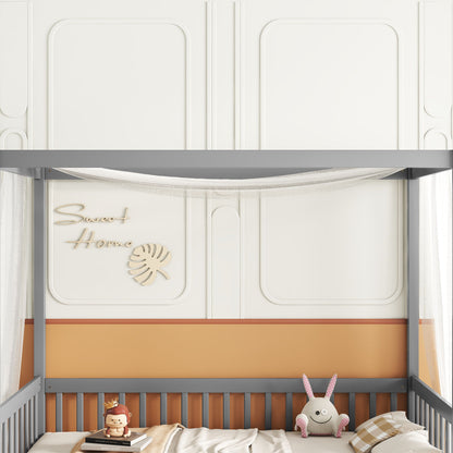 A cozy nursery with a gray crib adorned with brown and white striped bedding, featuring soft toy rabbit and monkey. The wall reads "Sweet Home" with a leaf design, while sheer white fabric drapes over the Canopy Frame Floor Bed With Fence, Guardrails.