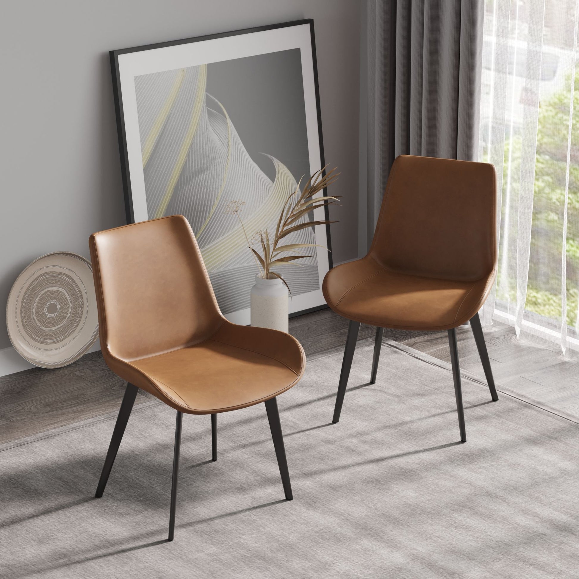 Two Modern Dining Chair Living Room Metal Leg Dining Chairs are on a gray rug in a minimalist room. A framed abstract artwork and a decorative plate lean against the wall, while sheer curtains reveal greenery outside.