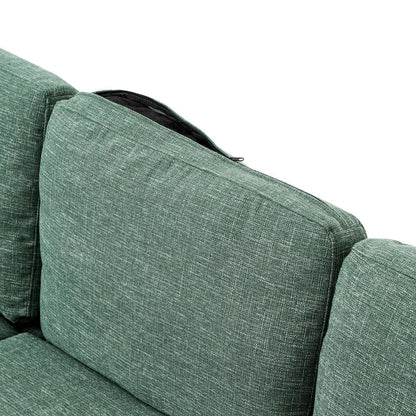 A close-up of the ValMinimal Sectional sofa in green fabric showcases a partially open zip on one of the back cushions, revealing the woven pattern and texture of the fabric.