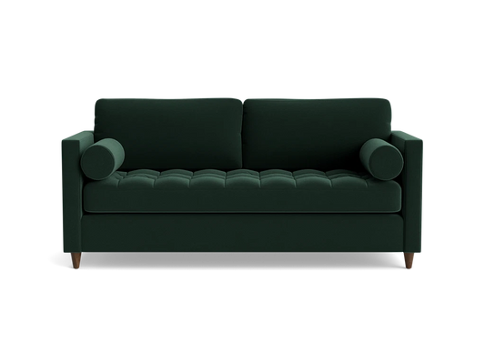 The Briar Sleeper Sofa is a dark green, mid-century modern piece featuring two cylindrical arm cushions and tufted seating. It is elevated on short wooden legs and presented against a plain black background.