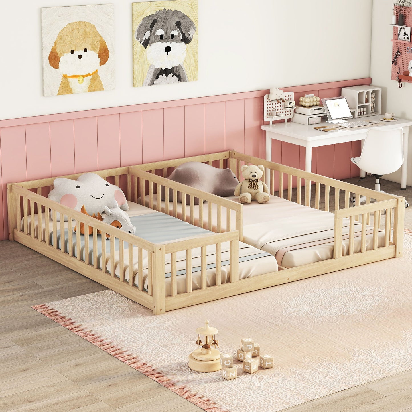 A cozy children's room with a Double Floor Bed With Fence features striped bedding and framed dog illustrations above. A desk with a computer, chair, and toys occupy the corner. A light rug adorns the wooden floor.