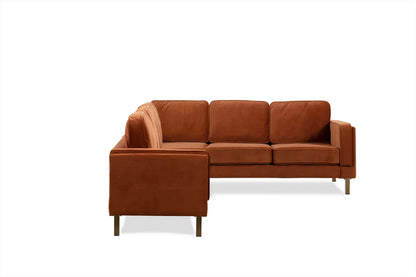 The Albany Corner Sectional in rust velvet, an L-shaped design with three cushioned seats and backrests and sleek metal legs, is set against a plain white background.