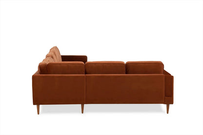 The Albany Corner Sectional in rust velvet showcases a modern design with three seats and wooden legs, viewed from the back against a white background.