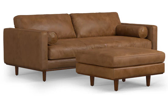 The Morrison 89-Inch Sofa and Ottoman Set in Genuine Leather offers a modern and minimalist aesthetic, featuring clean lines, a warm brown leather finish, and sturdy wooden legs.