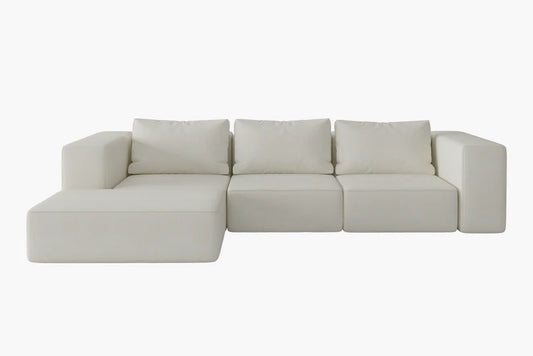 The Atlas Modular Sofa by Acanva is a modern white sectional with three back cushions and a left-facing chaise, set against a plain white background.