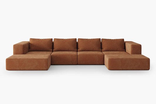 The Atlas Modular Sofa by Acanva is a spacious, brown L-shaped seating arrangement with plush cushions, set against a plain white background. The modular pieces are seamlessly joined to create a cohesive seating area.