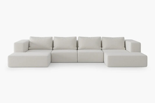 Introducing the Atlas Modular Sofa by Acanva: a minimalist, light gray modular sofa featuring thick cushions on a white background. This stylish piece includes six sections, comprising two armrests and four cushioned seats.