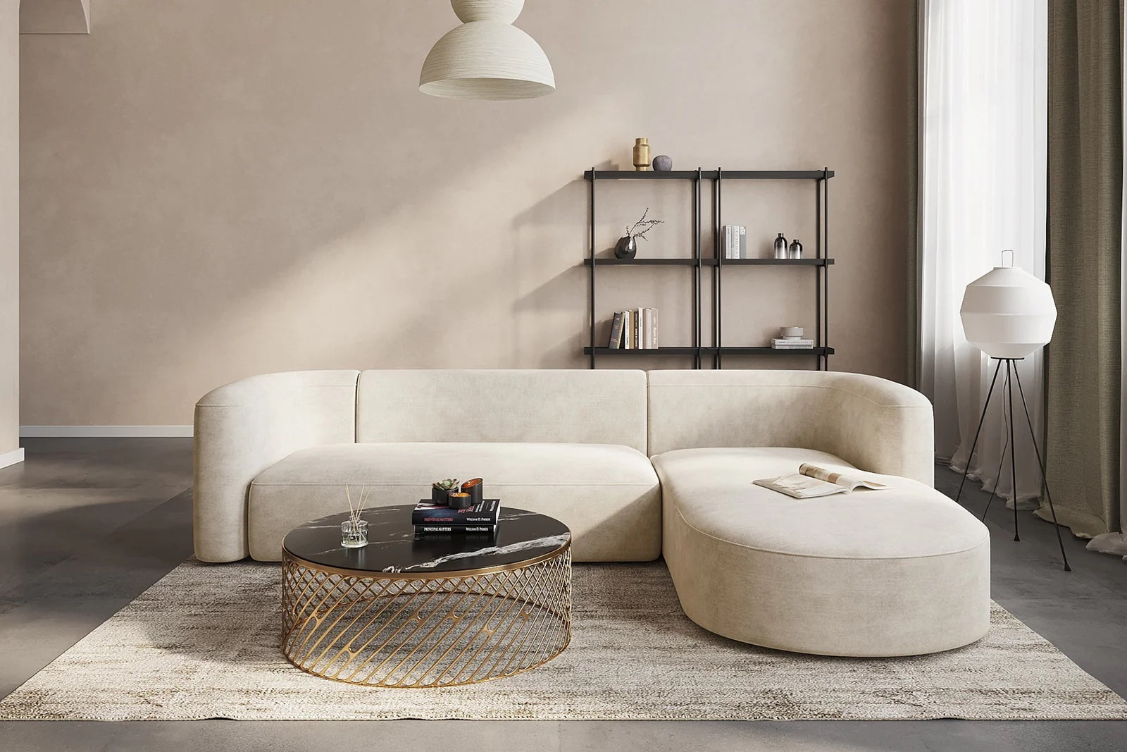 Beige, rounded sectional sofa with a black and gold coffee table in front of it. 