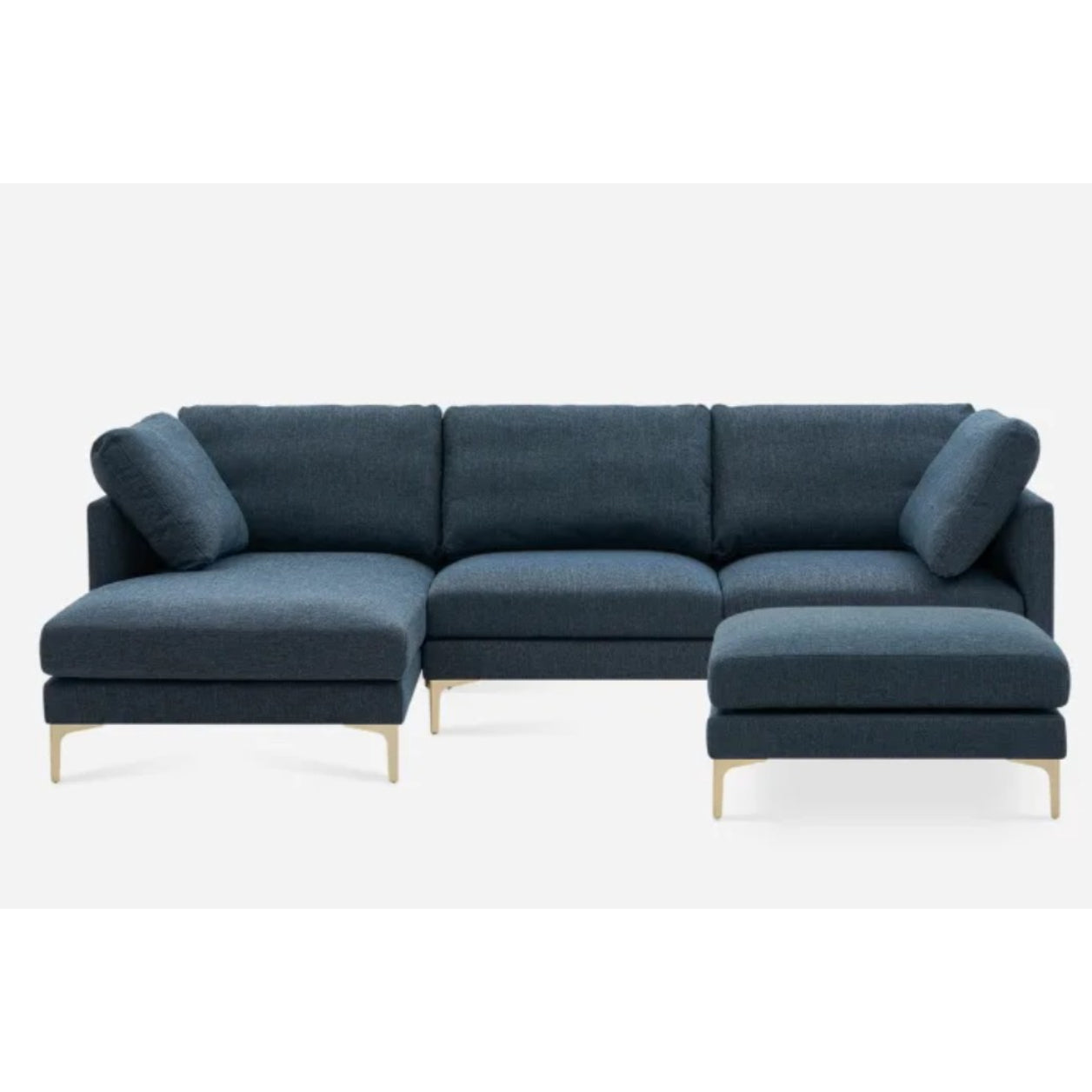 A modern, L-shaped sectional sofa with dark blue upholstery and light wooden legs, featuring plush cushions and a chaise lounge on the left side, set against a plain white background.