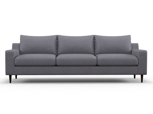 The Alex Sofa is a modern, three-seater piece with a minimalist design, featuring clean lines, plush cushions, and dark wooden legs. The grey fabric is soft and durable, making it an ideal addition to a contemporary living room.