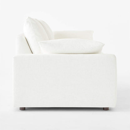 Side view of the Algora 100" White Performance Fabric Sleeper Sofa, featuring plush cushions and a minimalist design, set against a plain white background. This sofa has a clean, sleek profile and appears comfortable.