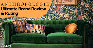 A green velvet couch with multicolored patterned throw pillows is set against a vibrant floral-patterned wallpaper. The text on the image reads "ANTHROPOLOGIE Ultimate Brand Review & Rating" with a logo of "couch.com" in the bottom left corner.