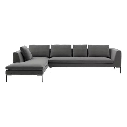 Introducing the Charles Left Arm Sectional Sofa by B&B Italia, a sleek and contemporary L-shaped sectional in gray, characterized by its clean lines and minimalist design. It comes with six back cushions and is elegantly supported by slender metal legs. The sofa includes a chaise on one side for extra lounging comfort.