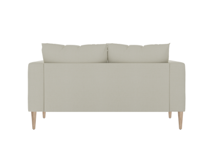 The back view of The Essential Loveseat showcases a minimalist design with two beige back cushions, sleek lines, and wooden legs, set against a plain black background.