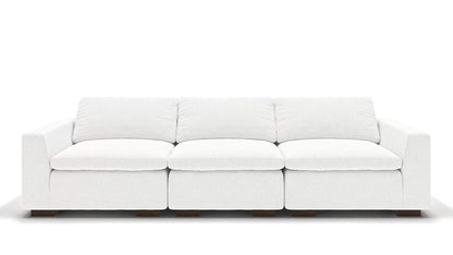 A sleek, minimalist 106" Like Butter sofa in luxurious Enzo/Cream leather, featuring plush cushions and blocky wooden legs, set against a plain white background.