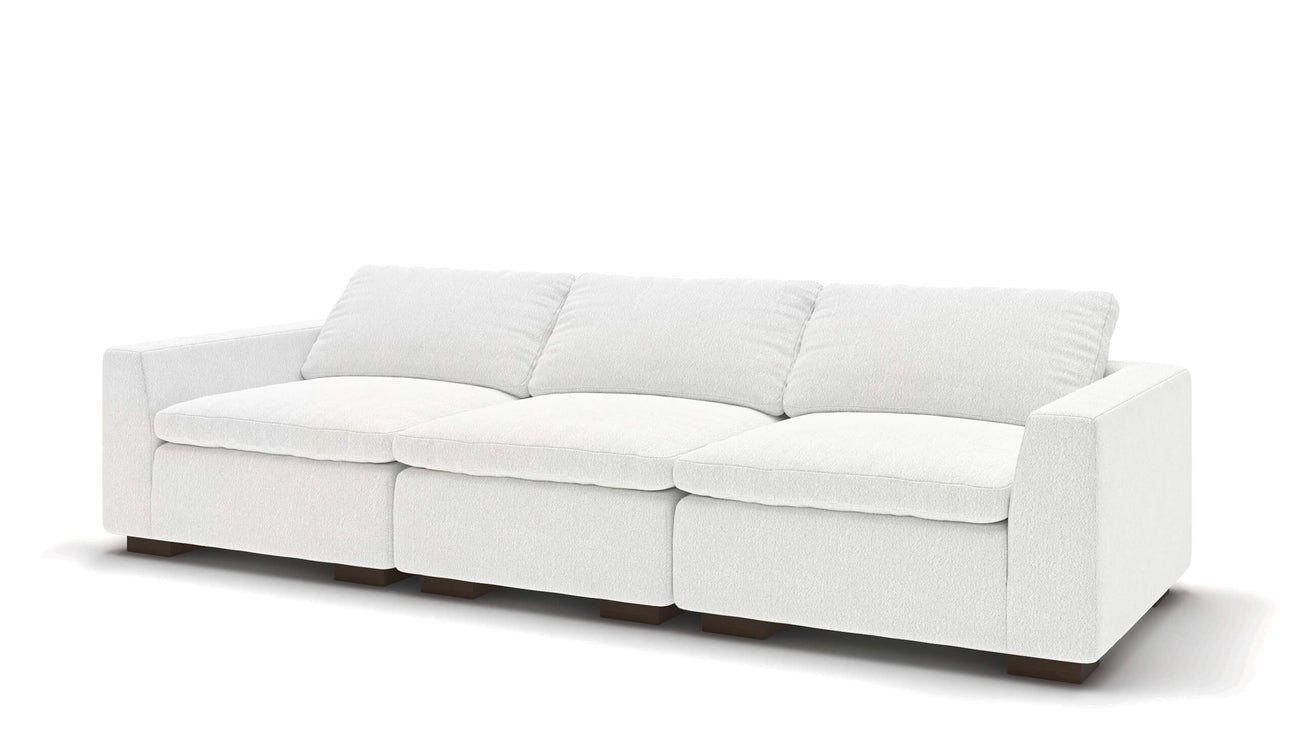 Introducing the Like Butter 106" Sofa in Enzo/Cream Leather, showcasing a minimalist design with straight lines and wooden legs. This modern white sofa includes three large cushions, all set against a clean, white background.