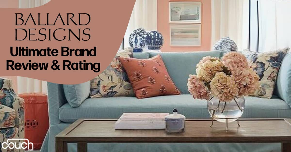 A living room with a light blue sofa adorned with floral and patterned cushions. A glass vase with pink hydrangeas sits on a coffee table in front of the sofa. The background features framed artwork. Text on the left reads "Ballard Designs Ultimate Brand Review & Rating.