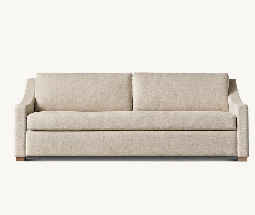 The Belgian Classic Slope Arm Premium Sleeper Sofa is a beige upholstered couch featuring straight lines and wooden legs. It comes with two seat cushions and two back cushions, showcasing a simple and modern design against a plain white background.