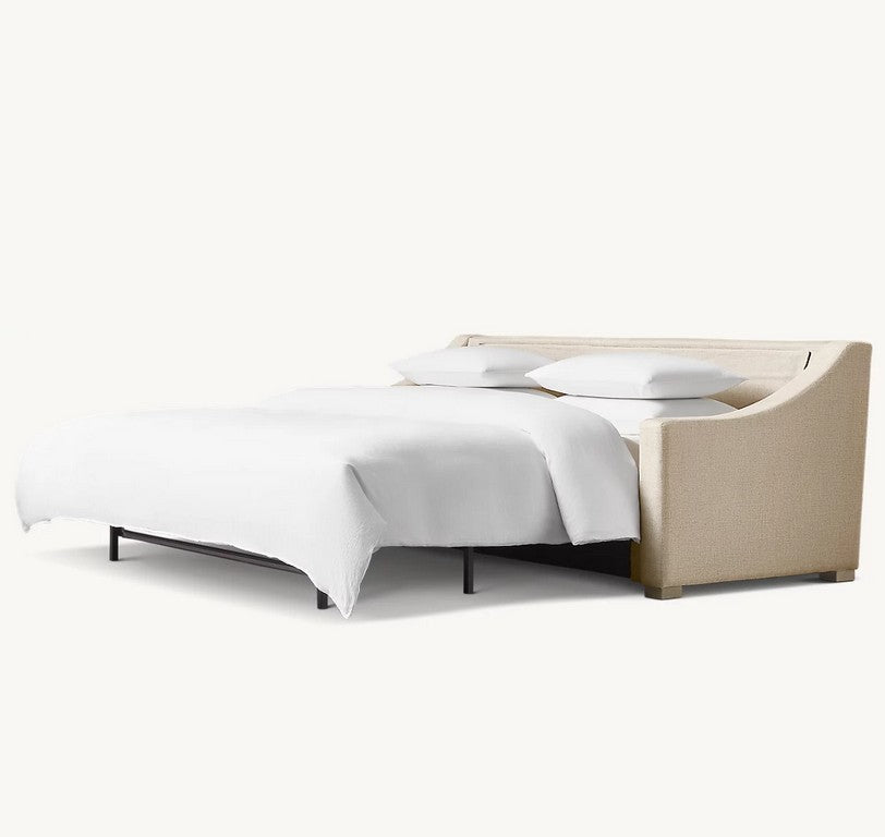 The Belgian Classic Slope Arm Premium Sleeper Sofa, featuring a beige upholstered sofa bed with a white mattress and two pillows, is unfolded into a bed. This piece boasts a modern, minimalist design with clean lines and is set against a plain, off-white background.