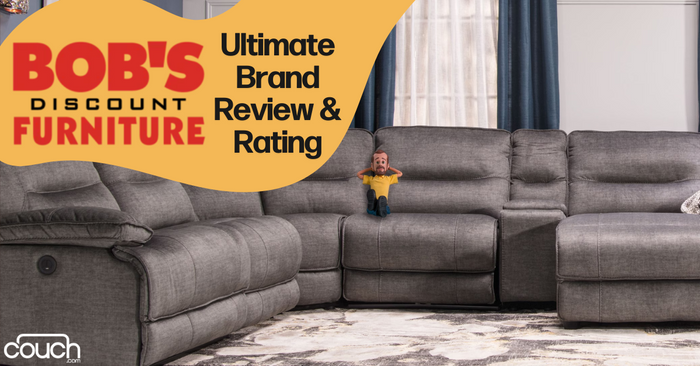 A grey sectional couch in a living room with blue curtains. A small figure of a man is sitting on the middle section. The corner of the image features an orange and yellow overlay with "BOB'S DISCOUNT FURNITURE" and "Ultimate Brand Review & Rating" text. The logo "couch.com" is at the bottom.