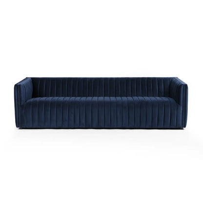 The Brandt 97'' Upholstered Sofa features a contemporary design with deep seats and a low-profile back, upholstered in rich, dark blue velvet. Its vertically tufted fabric adds a touch of luxury and sophistication. The sofa is equipped with wide armrests and showcases a sleek, minimalist aesthetic against a plain white background.