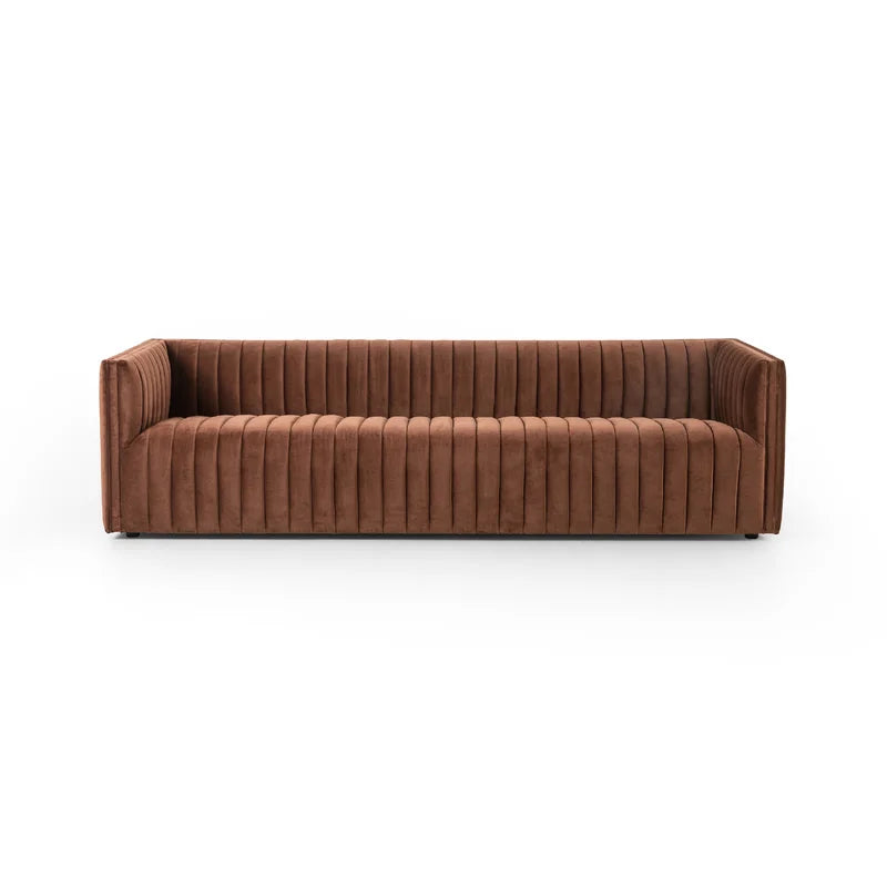 The Brandt 97'' Upholstered Sofa, featuring a brown velvet finish with vertical tufted stitching and square arms, is set against a white background. This sofa boasts a modern, streamlined design, offering both comfort and style.