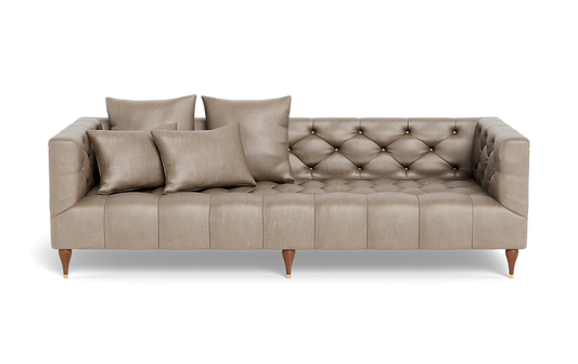 Introducing the Ms. Chesterfield Leather Custom Sofa: a beige, tufted masterpiece in mid-century modern design with wooden legs accented by gold caps. It includes five matching throw pillows and boasts an angular shape with button details for a stylish and elegant appearance.