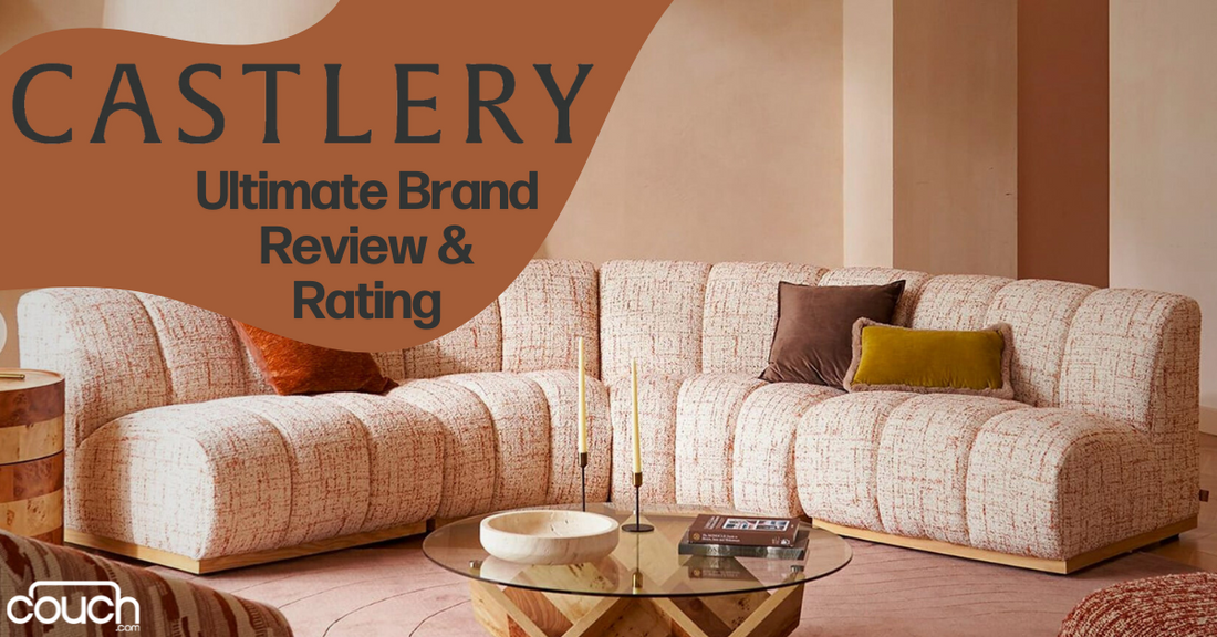 A cozy living room featuring a stylish L-shaped sofa with a textured beige fabric, adorned with brown and mustard throw pillows. A round glass coffee table with a wooden base is in front. The text reads "CASTLERY Ultimate Brand Review & Rating." The corner has the "couch.com" logo.